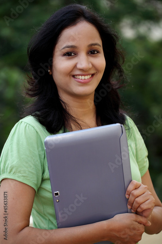 Young female student working with tablet computer