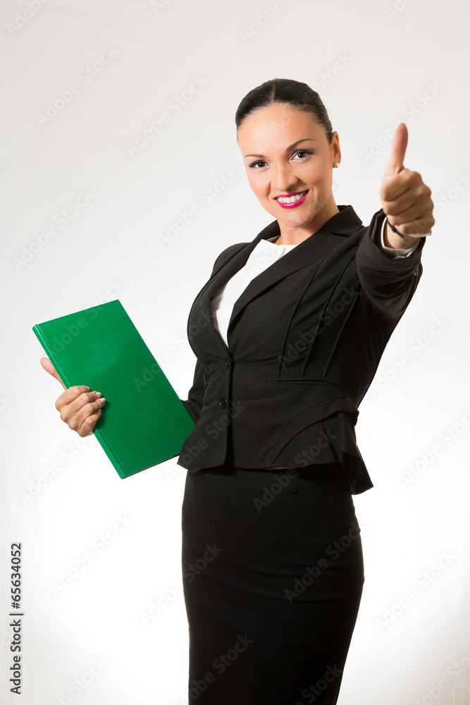 Black hair business dressed woman holding book and hand up Black hair business dressed woman holding book and hand up