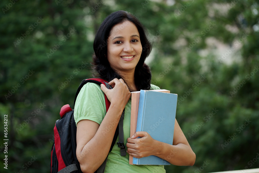 Fototapeta premium Happy young female student at college campus