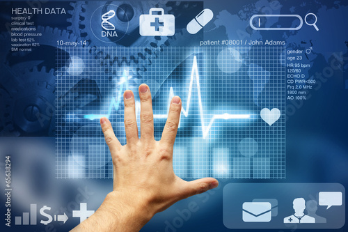 hand touching screen with medical data