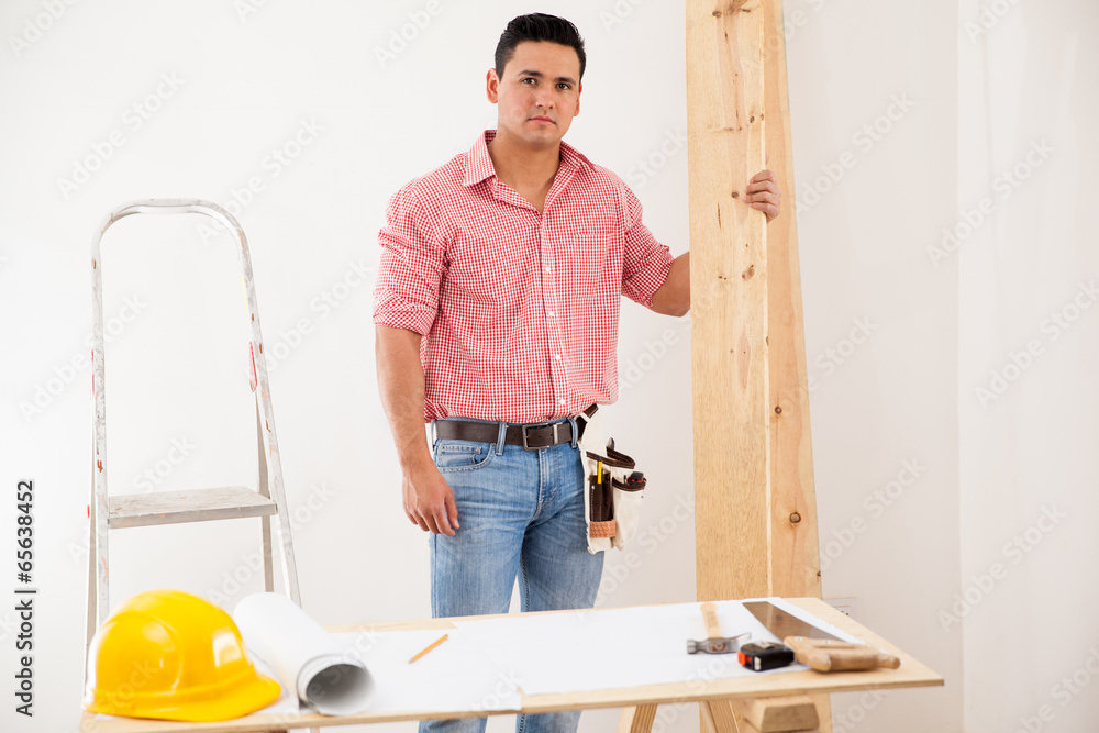 Young contractor at work at a house Young contractor at work at a house
