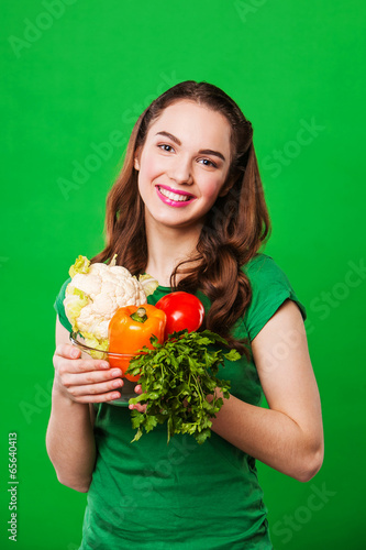 close up portrait of young woman with vegetables.