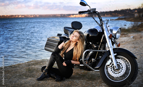 Stylized photo of young beautiful woman and bike