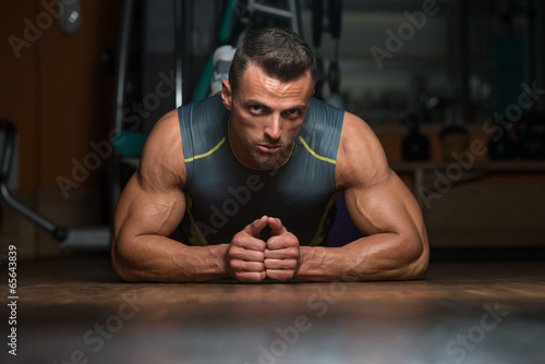 Young Man Doing Press Ups In Gym