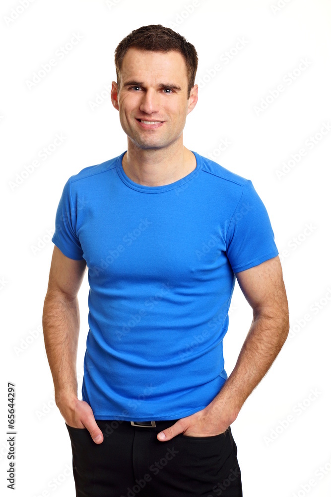 Fototapeta premium Handsome man in blue shirt with hands at pockets
