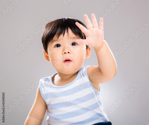 Adorable baby boy hand up