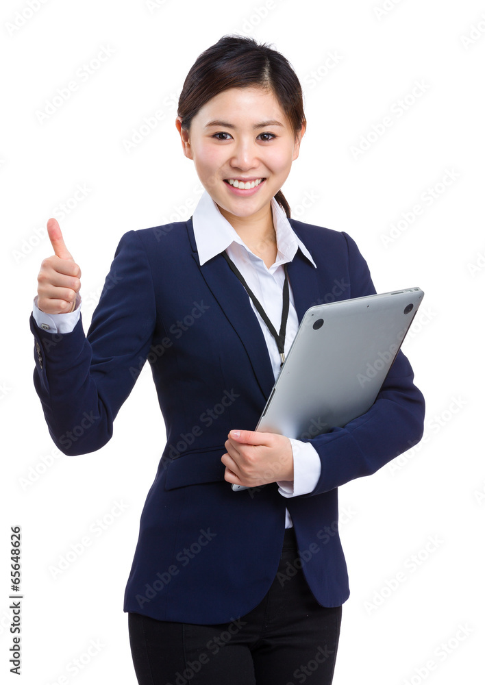 Young businesswoman holding laptop with thumb up