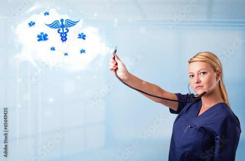 Young doctor with abstract cloud and medical icons photo