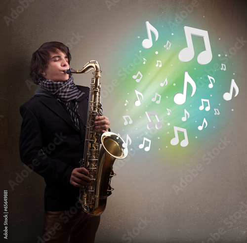 Young musician playing on saxophone while musical notes explodin photo