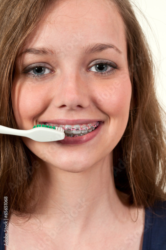 Beautiful Teenage Woman Brushing Teeth