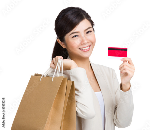 Happy woman using credit card for shopping