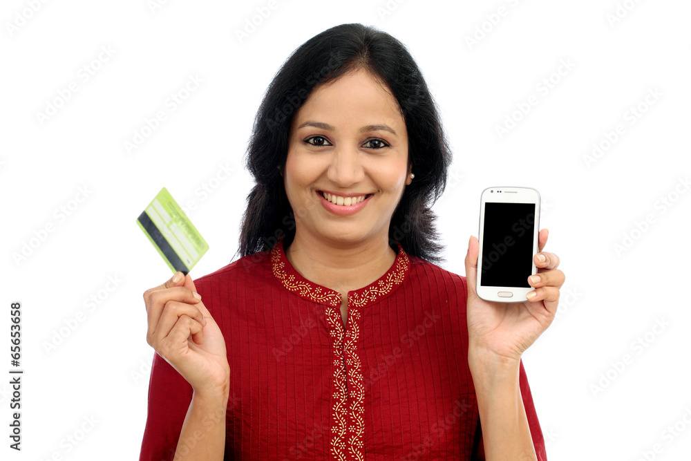 Happy young woman holding smart phone and credit card Happy young woman holding smart phone and credit card