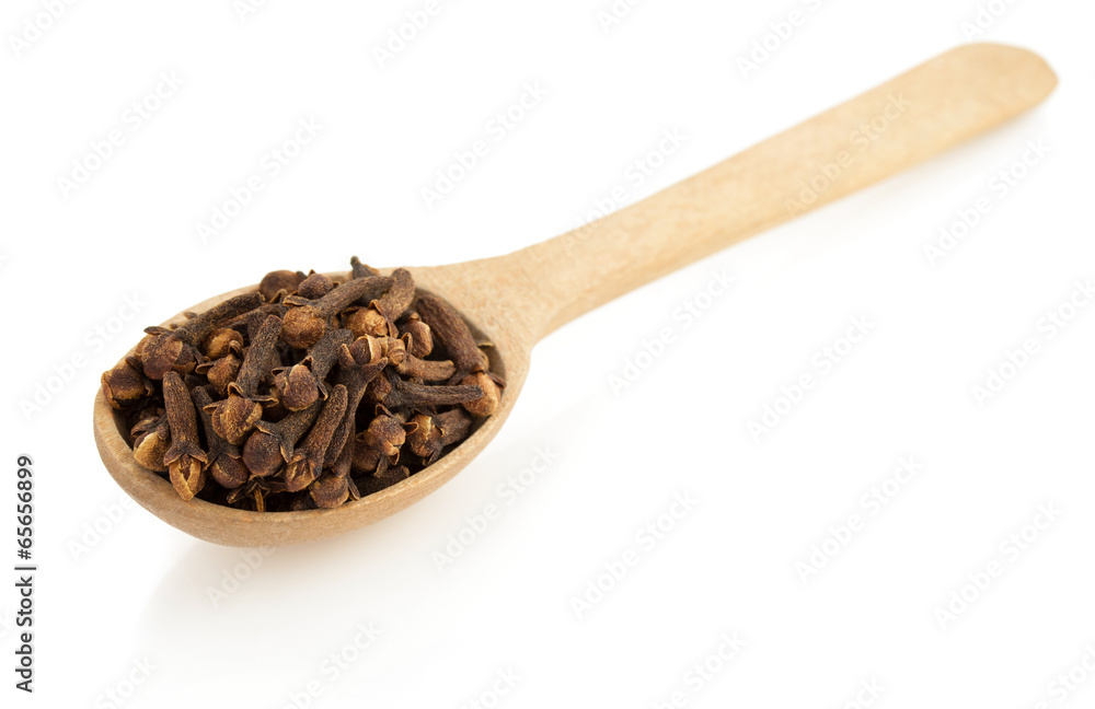 clove spices and spoon on white clove spices and spoon on white