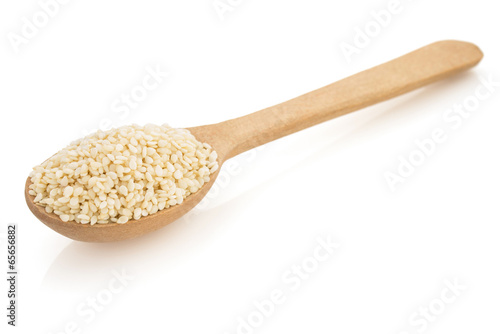sesame seed in spoon on white