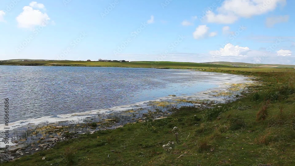 By the side of a tranquil loch in Orkney, Scotland By the side of a tranquil loch in Orkney, Scotland