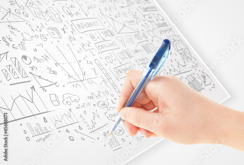 Human hand sketching ideas on a white paper