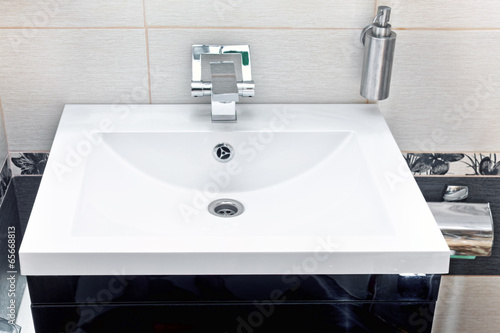 White sink and soap dispenser.