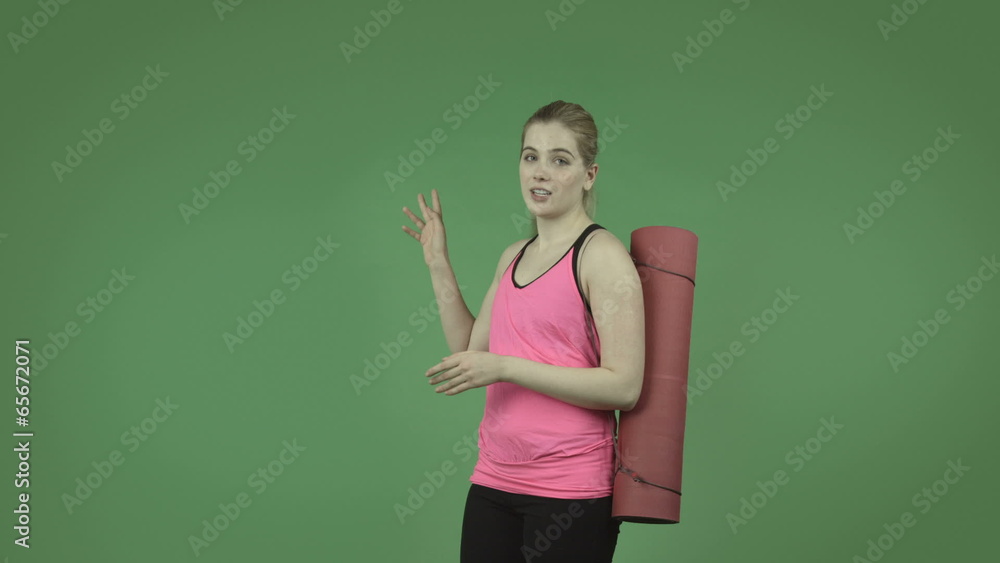 attractive caucasian sporty girl isolated on green talking and attractive caucasian sporty girl isolated on green talking and