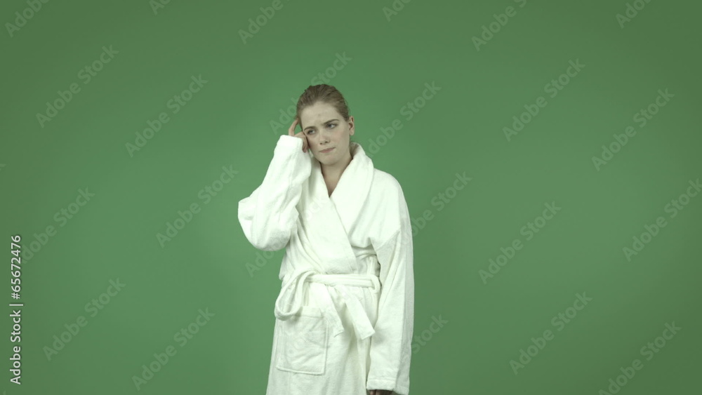 attractive caucasian girl in bathrobe isolated on green thinking attractive caucasian girl in bathrobe isolated on green thinking