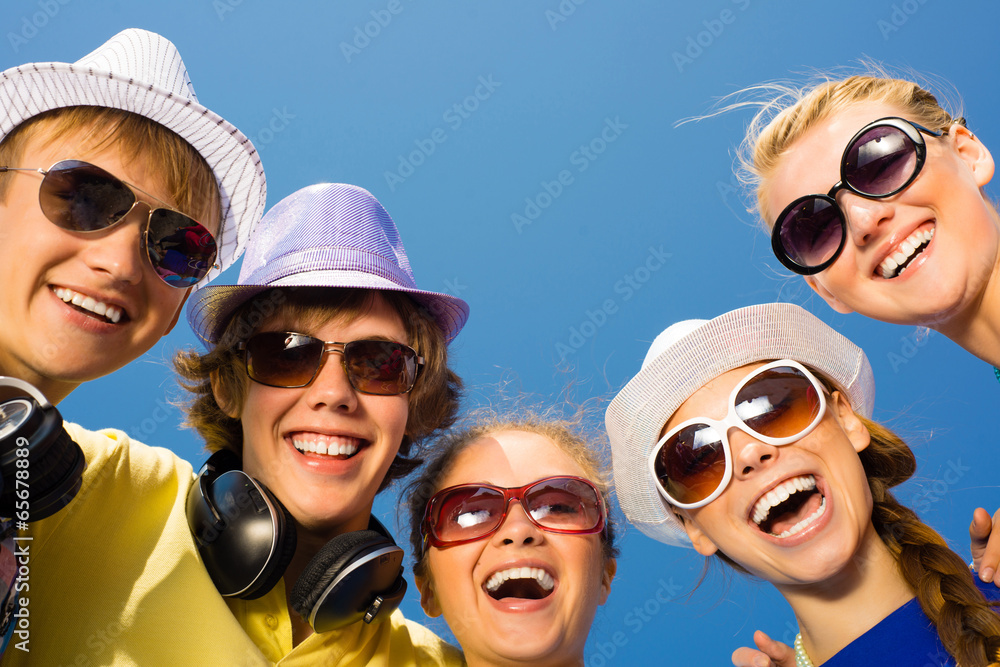 group of young people wearing sunglasses and hat group of young people wearing sunglasses and hat