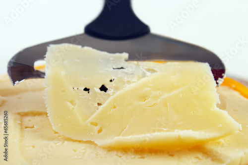 Closeup of cheese with slicer , shallow dof