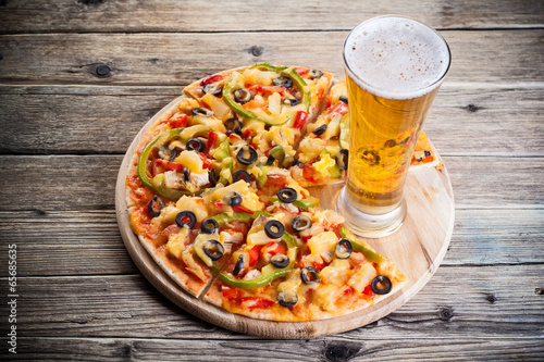 pizza on the table with a glass of beer