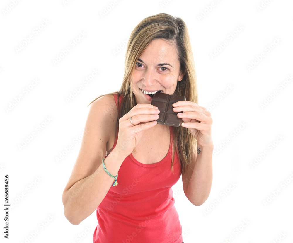 Woman eating big chocolate bar forgetting about diet Woman eating big chocolate bar forgetting about diet
