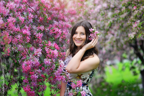 Beautiful smiling girl in a spring garden