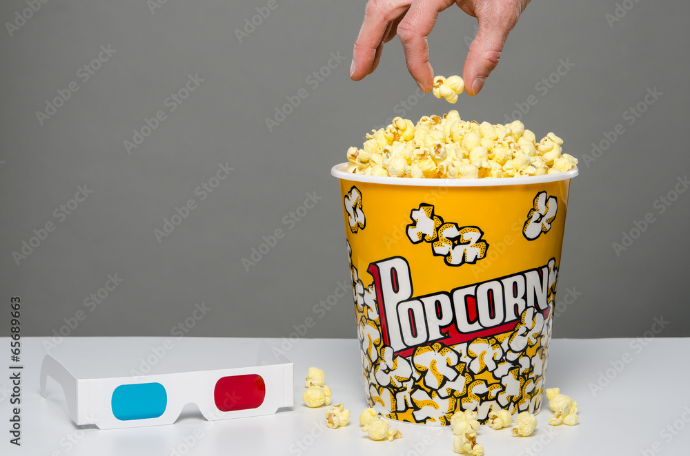 Fototapeta premium Hand reaching for popcorn