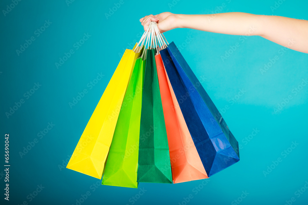Colorful shopping bags in female hand. Sale retail
