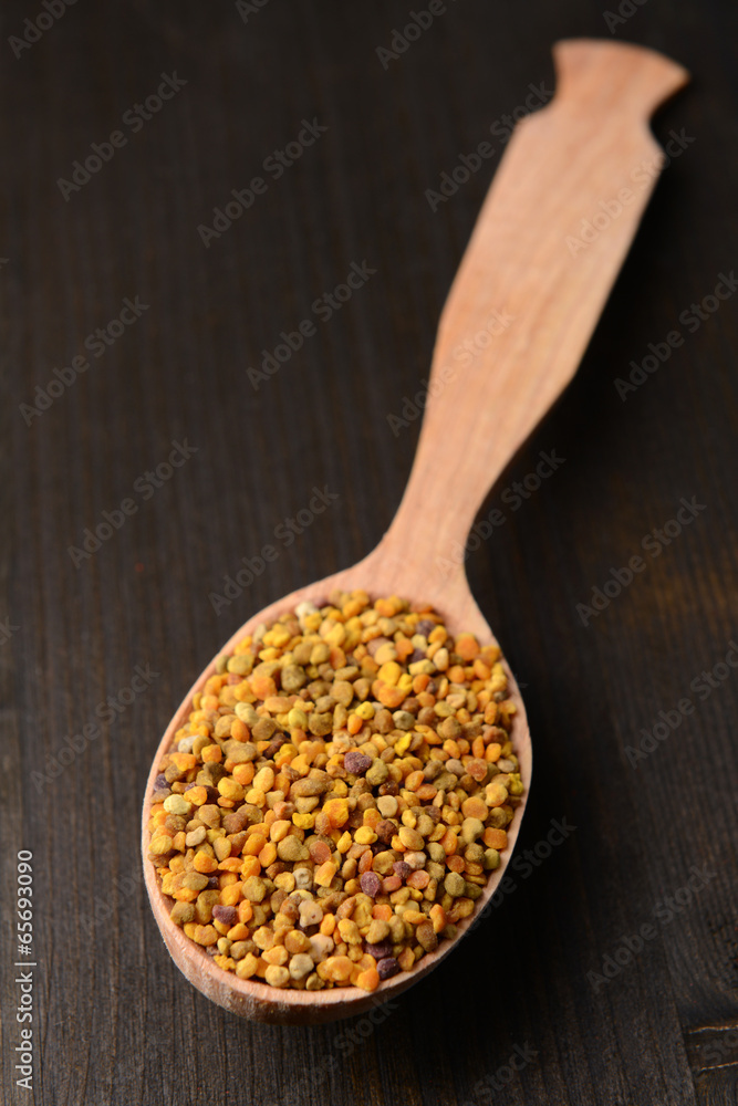 Spice pollen in spoon on wooden background Spice pollen in spoon on wooden background