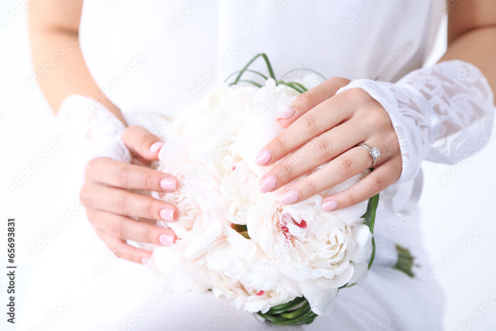 Bride holding wedding bouquet of white peonies, close-up Bride holding wedding bouquet of white peonies, close-up