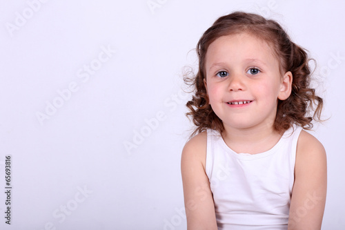 Beautiful small girl on light background