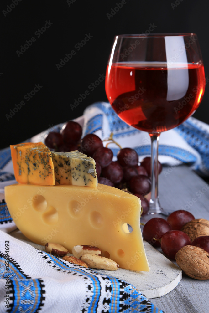 Different kinds of cheese with wine on table close-up Different kinds of cheese with wine on table close-up