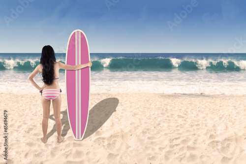 Beautiful young woman with surfboard 1
