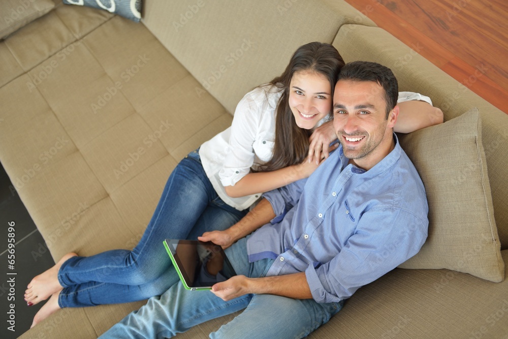 couple at home using tablet computer couple at home using tablet computer