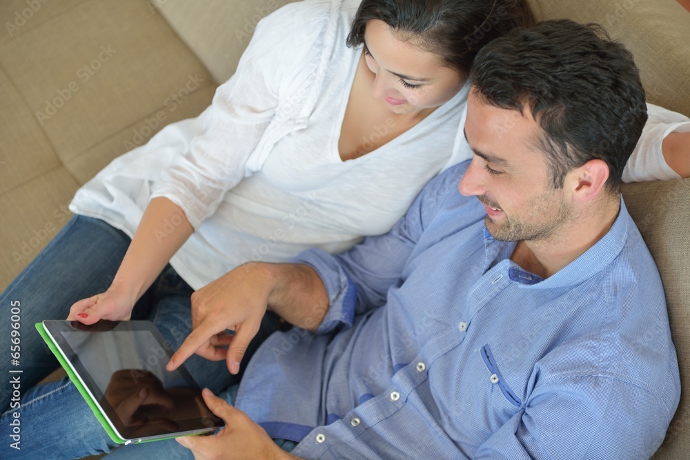 Fototapeta premium couple at home using tablet computer