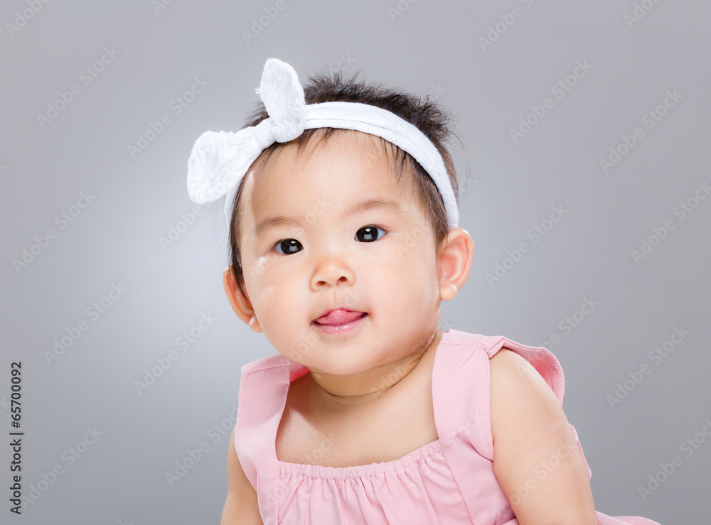 Adorable baby girl with lick sticking out Adorable baby girl with lick sticking out