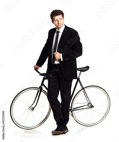 Attractive man in a classic suit with a bicycle on a white