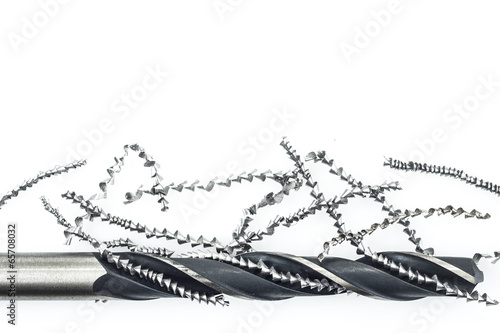 Drill and metal shavings on white