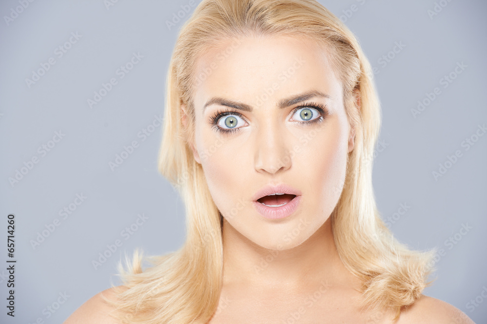Beautiful woman with a shocked expression Beautiful woman with a shocked expression