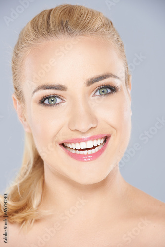 Happy blond woman with a beaming toothy smile