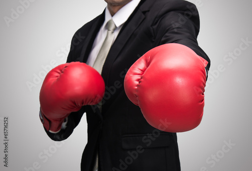 Businessman standing posture in boxing gloves isolated