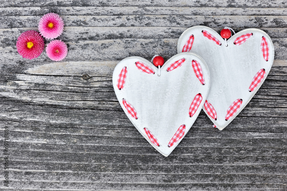 Two hearts with flowers on a wooden background old Two hearts with flowers on a wooden background old