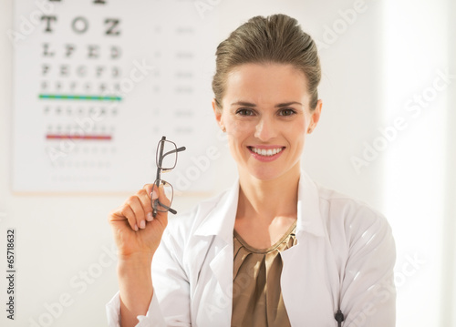 Happy ophthalmologist doctor woman with eyeglasses