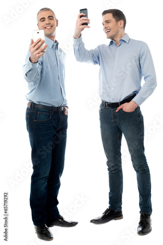 Two young men using their phone