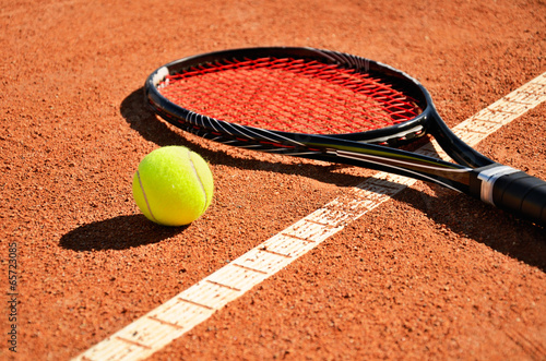 tennis ball and racket is on the carpet court horizontal © Tanya Rusanova