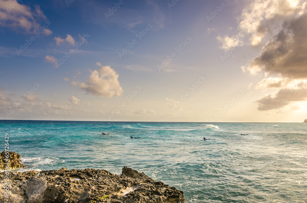 Sunset in Barbados with Surfers waiting for the Right Wave