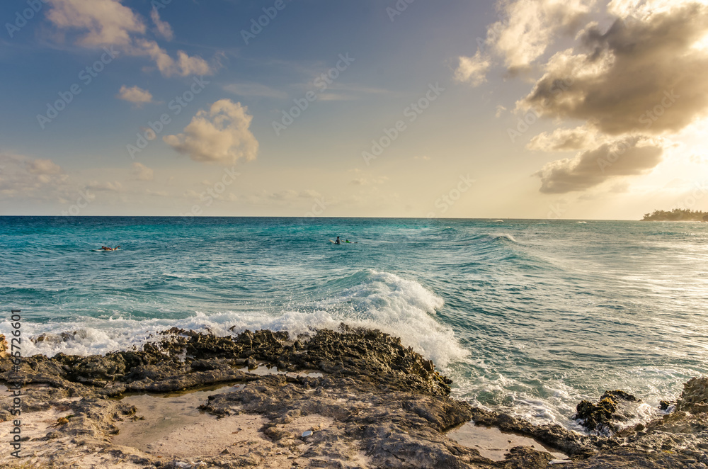 Surfers off the Coast of Barbados at Sunset