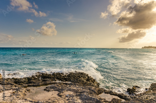 Fototapeta Naklejka Na Ścianę i Meble -  Surfers off the Coast of Barbados at Sunset